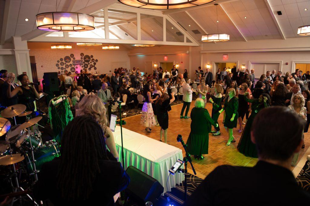 People dancing to live music at the Northwood Rocks Auto Show Gala